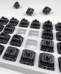 Oil King V2 Pre-Lubed Black Linear Keyboard Switches Pack Of 10 displayed in a tray