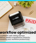 Slick Self Inking Rubber Stamp With Bold Red Ink For Quick Paid Documents On Desk With Paperwork and Stationery.