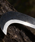 Close-up of blade on Compact 13.5 Inch Machete Sickle Tool with curved blade for weeding and pruning, carbon steel material.