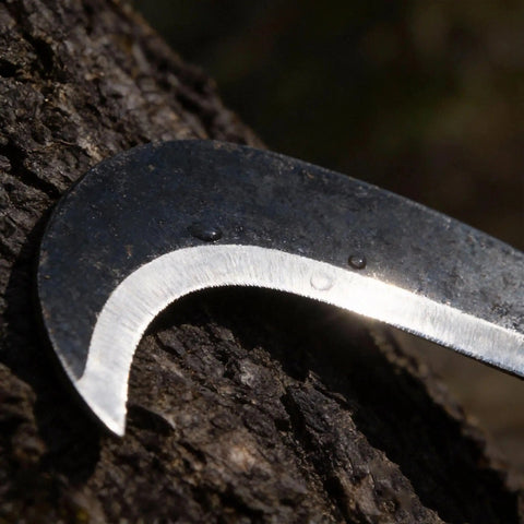 Close-up of blade on Compact 13.5 Inch Machete Sickle Tool with curved blade for weeding and pruning, carbon steel material.