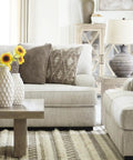 Living room with gray sofas, wooden coffee table, vase with sunflowers, and Magan 285 Textured Bronze Metal Table Lamp beside sofa.