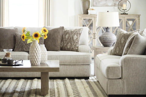 Living room with gray sofas, wooden coffee table, vase with sunflowers, and Magan 285 Textured Bronze Metal Table Lamp beside sofa.