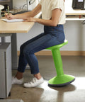 Person seated on SitWell Wobble Stool With Adjustable Height For Active Seating In Classrooms And Libraries Grassy Green Boosts Posture