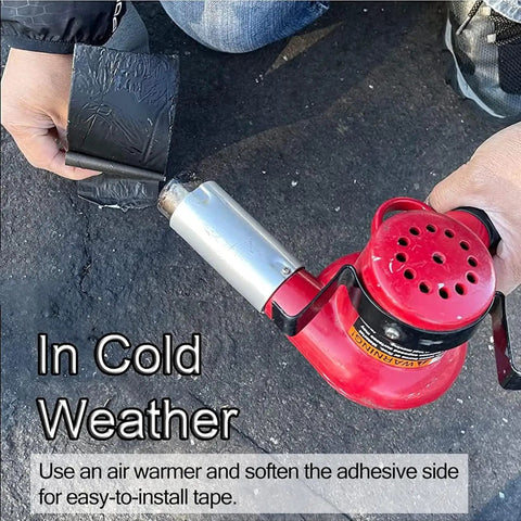 Darn Tough Self Adhesive Asphalt Crack Tape Waterproof Heavy Duty Concrete Patch Roll For Beat Up Driveway Sidewalk No Fuss Repair Parking And Roadway Surfaces being applied with a heat gun for easier installation.