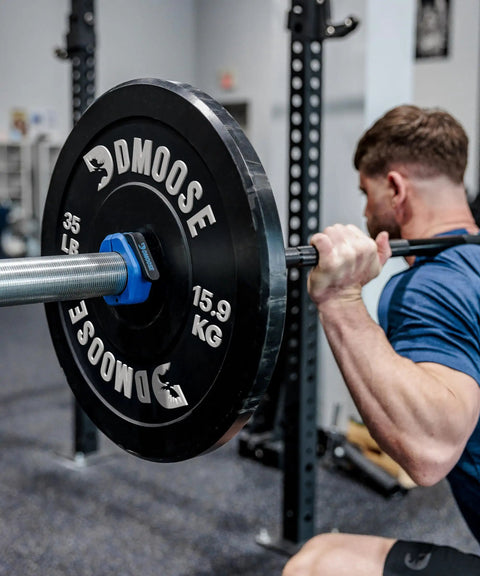 Man using barbell with Two Inch Quick Release Barbell Clips With Anti Slip Lining For Easy On Easy Off Secure Weightlifting