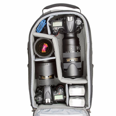 StreetWalker Pro V2 Camera Backpack TT476 open showing organized camera gear with padded dividers, lenses, and accessories.