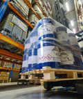 Forklift carrying wrapped barrels in warehouse, showcasing Red Up Arrow Shipping Labels Orientation Stickers, Heavy Duty 3 x 4.125 Inch.