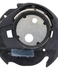 Bobbin case close-up, black plastic with metal insert and blue lint brush for sewing machines