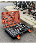 Premium 150 Piece Socket Ratchet Wrench Set With Sturdy Hanging Tray For Auto Repair And Household Fixes displayed outdoors on pavement.