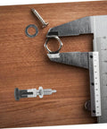 Heavy Duty Stainless Steel Spring Loaded Latch Pin Indexing Plunger Locking Knob With Knurled Handle and Quick Release Pull on a wooden surface.