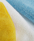 Microfiber cleaning cloths; blue, white, and yellow; close-up fabric texture