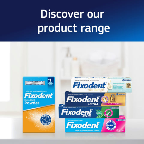 Various Fixodent adhesive products displayed, including Fixodent Extra Hold Powder and tubes with multiple formulas in a bathroom setting.