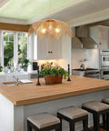 Handcrafted Rattan Chandelier With Three Bright Bulbs For Your Dining Room Or Kitchen Island above a wooden kitchen island.