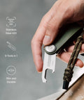 Hand holding Ultra Slim Stainless Steel Multi Tool V2 with titanium coating, showing bottle opener and package cutter in use