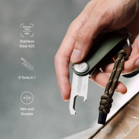 Hand holding Ultra Slim Stainless Steel Multi Tool V2 with titanium coating, showing bottle opener and package cutter in use