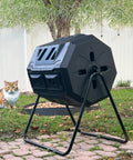 42 Gallon Black Outdoor Garden Compost Tumbler Bin With Dual Chambers Rotating For Continuous Composting And Yard Waste, in garden setting