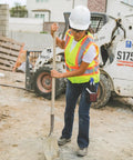 Men's High Vis Reflective Breakaway Safety Vest With Contrast Mesh And Quick Hook Closure Ansi Class Two Jobsite Ready Traffic Control Utility Gear Lime Orange Trim Real Big Size Built Tough worn by a worker shoveling on a construction site.