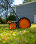 Side view of Old School 18 Inch Manual Reel Mower With 7 Blade Ball Bearing Reel Push Style Adjustable Cutting Height on lawn