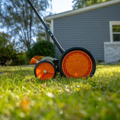 Side view of Old School 18 Inch Manual Reel Mower With 7 Blade Ball Bearing Reel Push Style Adjustable Cutting Height on lawn