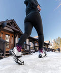 Heavy Duty Tungsten Carbide Spikes For Ice Walkers Large X Large Black Traction Cleats on snowy sidewalk under sunny sky.