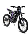 Kicking Up Serious Dust On This Heavy Duty Electric Dirt Bike Delivering 60 Mph with black and purple design, dual suspension, and off-road tires.