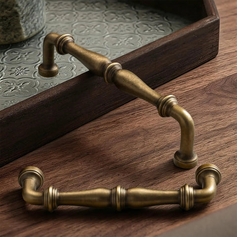 Two Pack Bronze Vintage Brass Cabinet Pulls 3.78 Inch Die Cast Hardware Handle for kitchen cabinets, laying on wood surface
