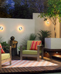 Outdoor patio decor with modern seating, ambient lighting, and lush greenery at night.