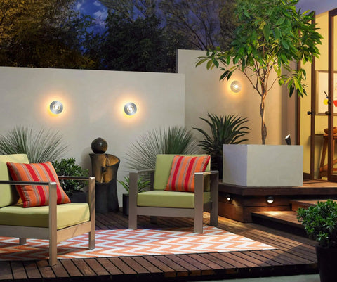 Outdoor patio decor with modern seating, ambient lighting, and lush greenery at night.
