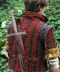 Person wearing Medieval Sword Back Holster for Cosplay Go To Adjustable Shoulder Sheath Belt With Cross Strap in a forest setting