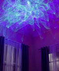 Room with Ark Lite LED Aurora Projector With Laser Nebula And Galaxy Lighting creating blue laser visuals on ceiling