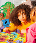 Teacher using 171 Piece Science Bulletin Board Set for Chemistry Periodic Table Posters in classroom setting with children.