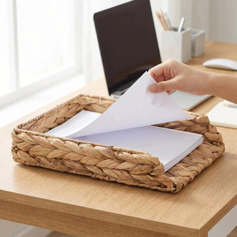 Hand placing papers in Water Hyacinth Paper Tray Organizer 3 Piece Desk Set For Home Office Open Front Mail Sorting Trays Active File Storage