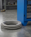 Rock Solid Stainless Steel Electrical Wire Conduit Flexible Corrugated Cable Sleeve Cover coiled on floor for organization.