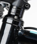 Close-up of black headset with Dope 12 Piece Aluminum Bicycle Headset Spacers Set For Mountain And Road Bikes installed.