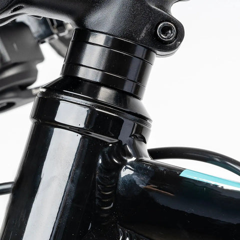 Close-up of black headset with Dope 12 Piece Aluminum Bicycle Headset Spacers Set For Mountain And Road Bikes installed.