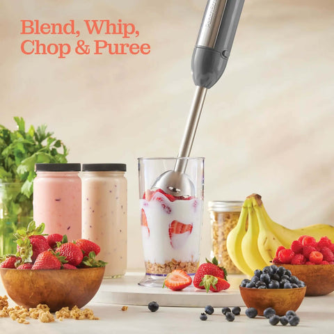 500 Watt Electric Hand Blender With Turbo Boost And Sharp Stainless Steel Blades For Smoothies Soups Purees And Baby Food Detachable Base Grey blending strawberries in a glass with yogurt and granola.
