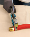 Top Shelf Center Punch Installer With Built In Cutter For 5/8 And 3/8 Inch Hose Clamps Knockout setup, tightening a red hose clamp on brass fitting.