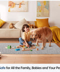 Child and dog playing on a gray office chair mat for hard floors 36 by 48 inches in a living room setting.