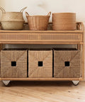 Wicker shelving unit with baskets on heavy duty non swivel drawer caster wheels 0.5 inch low profile set of four with rigid frame.