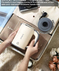 Person packing the On The Go Grab And Go Portable Electric Kettle 24oz Mini Travel Kettle for Camping and Office into a suitcase