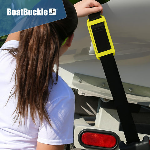 Person attaching 2 Inch Ratchet Strap Protectors For Trailer Tie Downs to boat, showing protective sleeve on strap