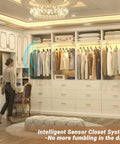 White Freestanding Closet System With 4 Motion Sensor Led Lights modular wardrobe organizer with clothes neatly arranged.
