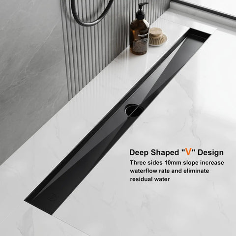 24 Inch Matte Black Linear Shower Drain With Bold Brick Pattern Grate and Quick Release V Channel on marble surface.