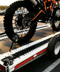 Self Retracting Ratchet Straps 4 Pack Lock It Down Heavy Duty Tie Down Strap For Pickup Truck Cargo Trailer Motorcycle Atv Utv With Killer Grip Robust Breaking Strength Secure Your Haul Tangle Free System Black One Inch By Twelve Feet securing motorcycle wheel on trailer.