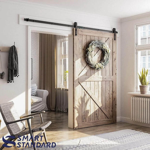 8.2 FT Sliding Barn Door Hardware Kit with J Shape hanger, installed on wooden door, showcasing modern space saving design in living room