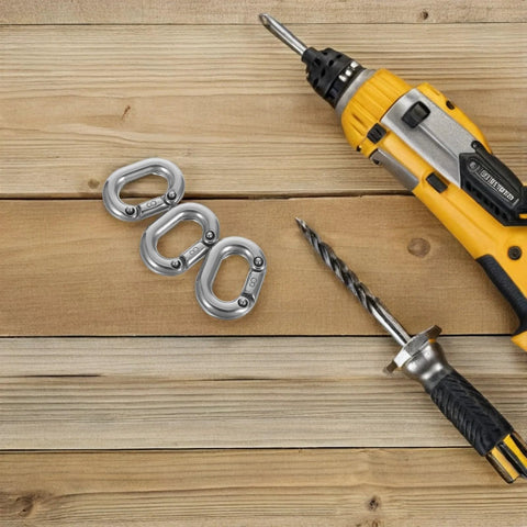 Three 8mm marine-grade stainless steel quick-link chain connectors on a wooden surface, with a drill and drill bit nearby.