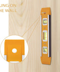 Nine Inch Magnetic Torpedo Level With Three Bubble Vials For Horizontal Vertical And 45 Degree Readings Shock Resistant ABS Frame Heavy Duty Magnetic Base Bright Orange On Site Construction And Woodworking Tool For Precise Layouts hung on wall