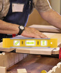 9 Inch Magnetic Box Level Torpedo Level With 3 Bubbles For 45 Degree 90 Degree And 180 Degree Angles in use on wooden surface