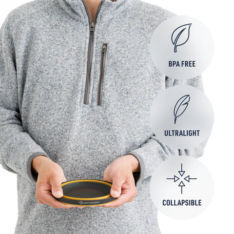 Man holding Frontier Ultralight Collapsible Bowl Large 30 Fl Oz Puffins Bill Orange showing BPA free and ultralight features