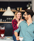 Couple in kitchen with Red Single Serve Coffee Maker With 2 In 1 Brew Pod Or Ground Coffee Five Brew Sizes Up To 14 Oz No Fuss Quick Brew